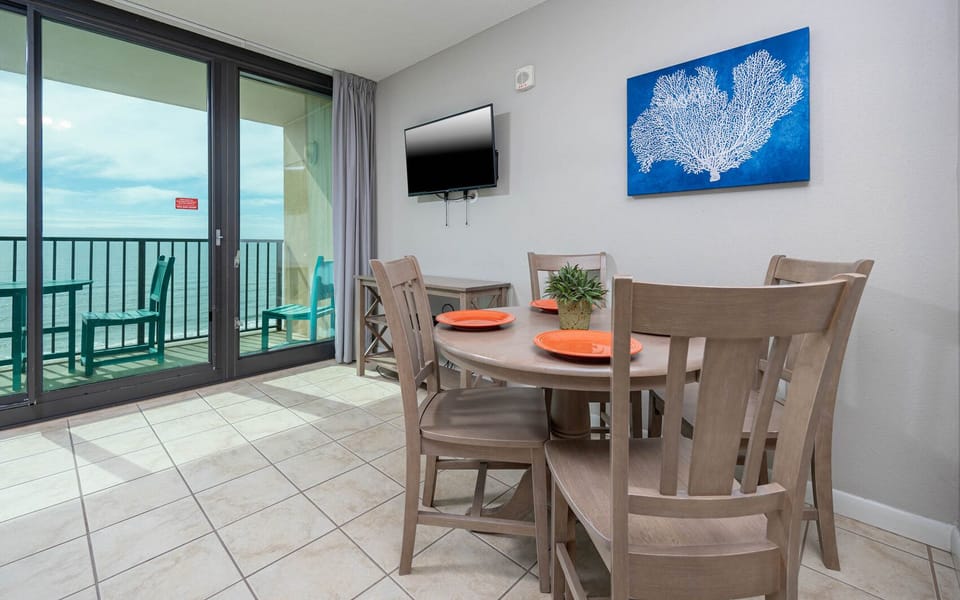Dine at the round table or relax on the chairs while enjoying the view through the large sliding glass doors