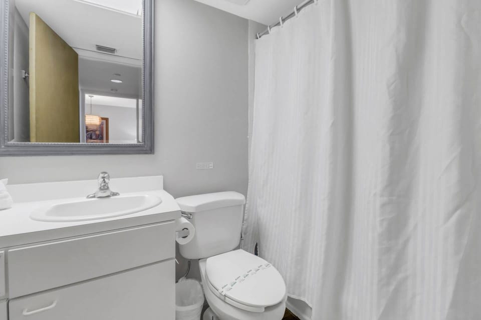 The guest bathroom features a full bathtub with shower, perfect if you are traveling with children.