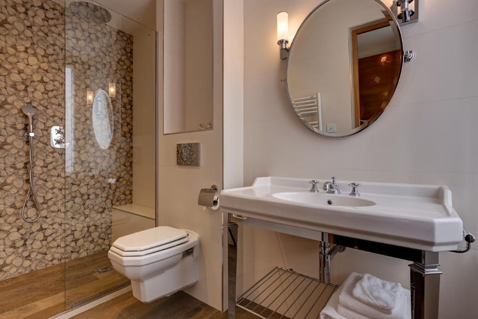 Shower, rainfall showerhead, hair dryer, towels