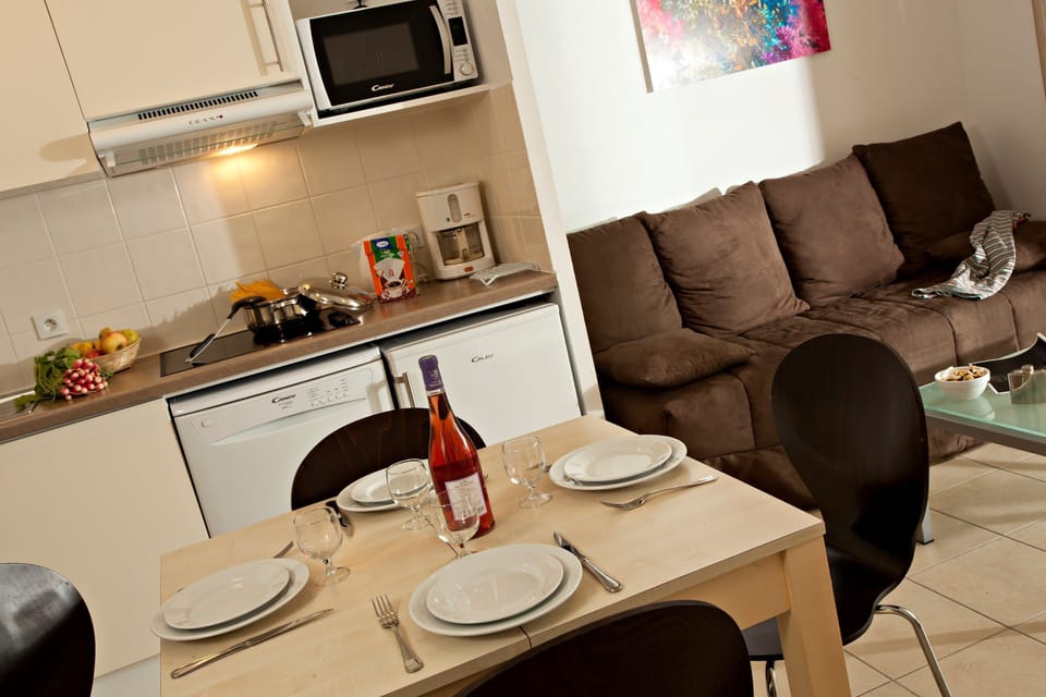 Prepare meals in the kitchenette and enjoy them at the dining table.