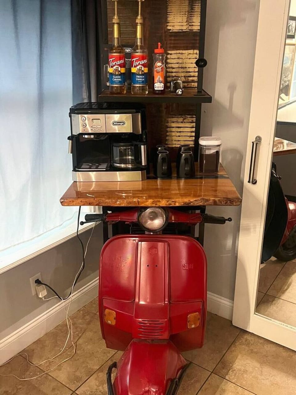 Unique coffee station with vintage Vespa scooter as bar base, espresso machine and live-edge wood countertop, Orlando vacation home