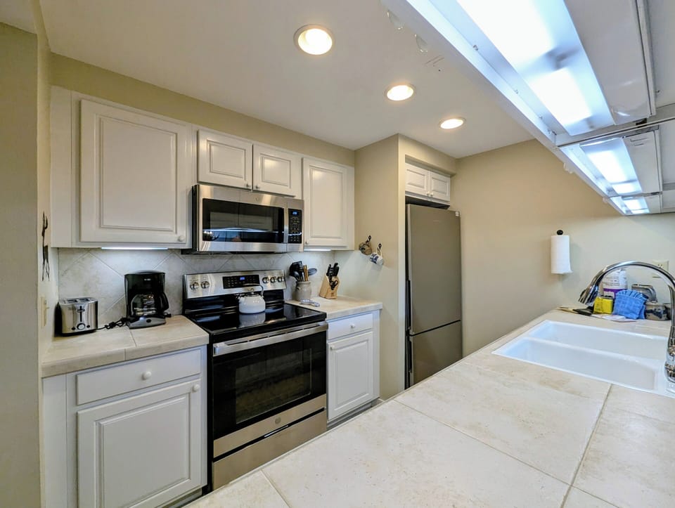 Your fully equipped kitchen features stainless steel appliances, plenty of counter space, and bright skylights that fill the room with natural light for your home-cooked meals.