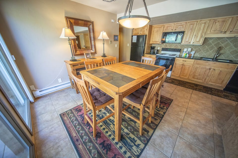 Dining area, kitchen and hallway to bedrooms
