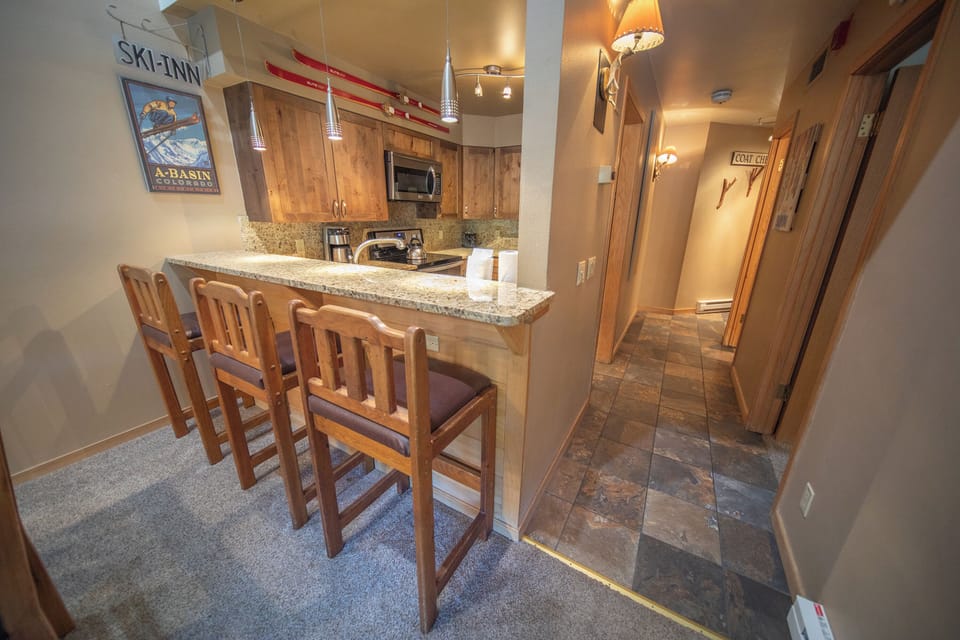Fully equipped kitchen with bar stool seating