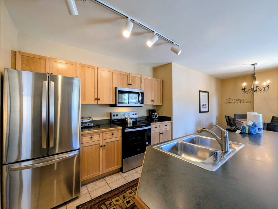 Cook your favorite meals in this fully equipped kitchen with stainless steel appliances, spacious countertops, and modern lighting—everything you need for a comfortable stay.