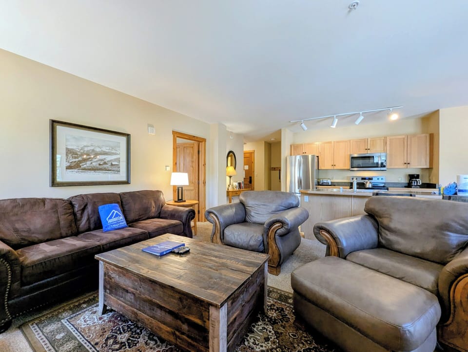 Sink into plush leather seating and feel instantly at home in your spacious open-concept retreat, where the fully equipped kitchen invites you to prepare meals with ease.