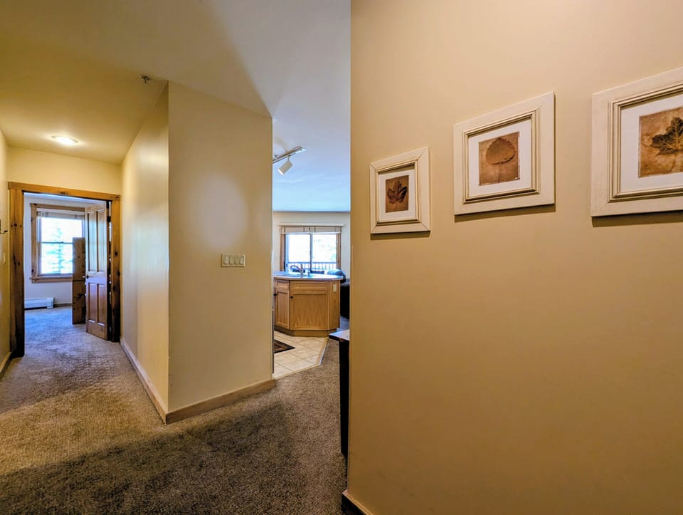 Step into your inviting hallway, where warm lighting and thoughtful décor create a welcoming entry to your comfortable living spaces.