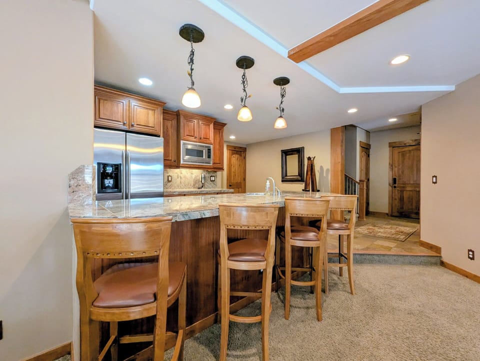This lower level wet bar great for entertaining w/full size fridge