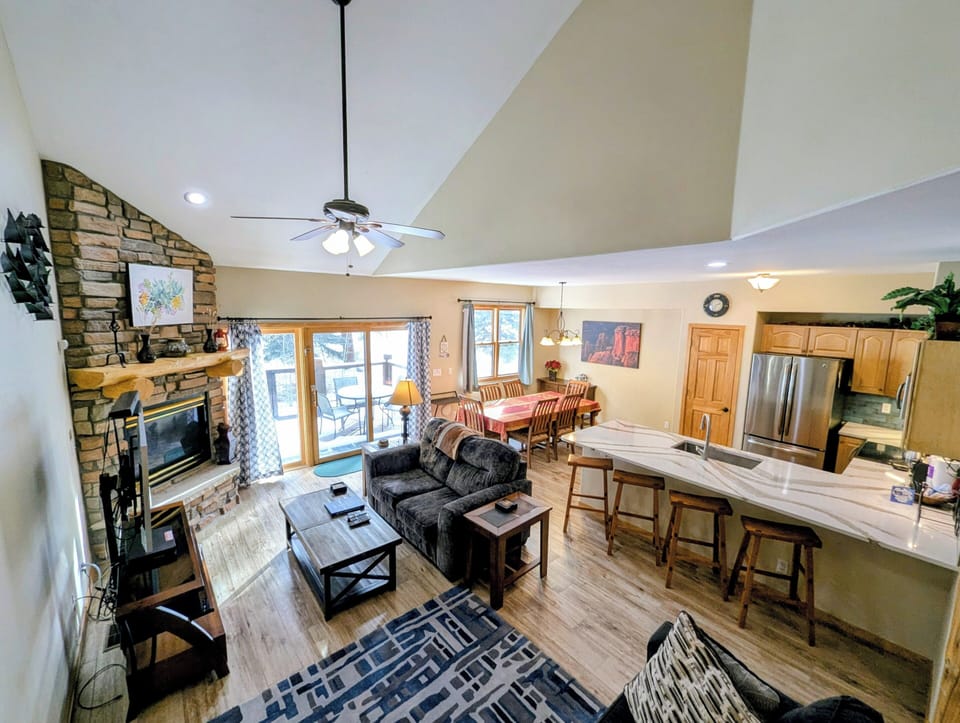 Relax in your open-concept retreat with stone fireplace, full kitchen, and cozy dining space perfect for mountain getaways.