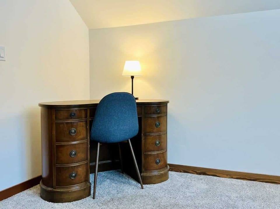 Upstairs bedroom with queen bed and twin bed with workspace