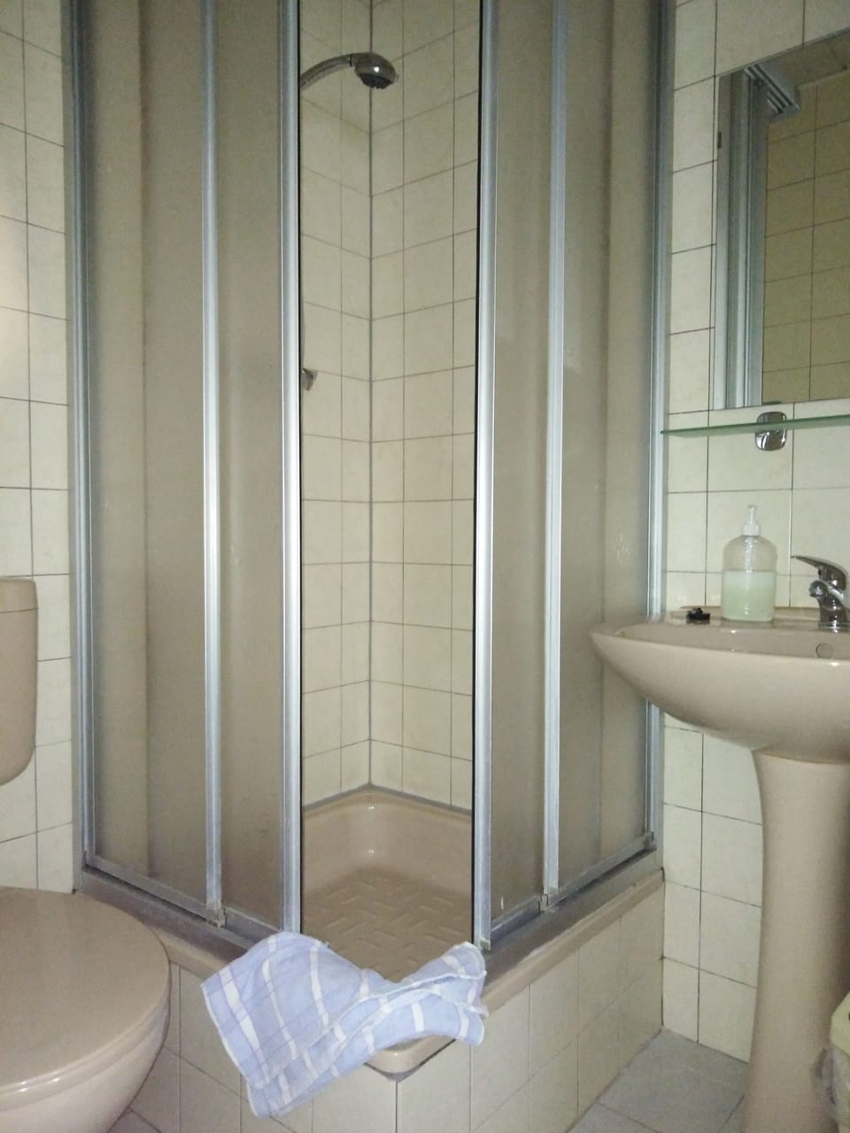 Shower, rainfall showerhead, towels, toilet paper