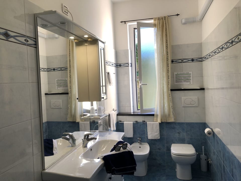 Shower, free toiletries, hair dryer, slippers