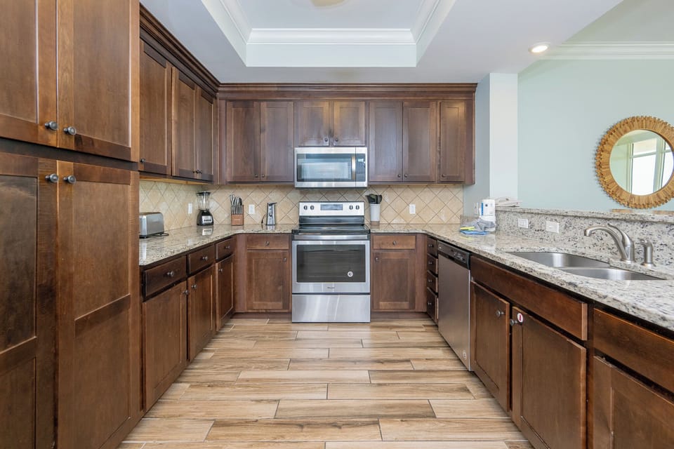 Prepare meals in the sleek kitchen, where stainless appliances and inviting counters await your culinary creations