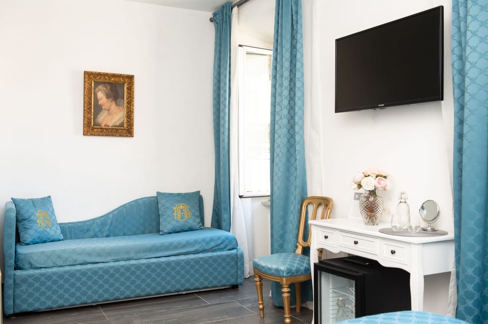 Deluxe Quadruple Room | Minibar, in-room safe, desk, laptop workspace