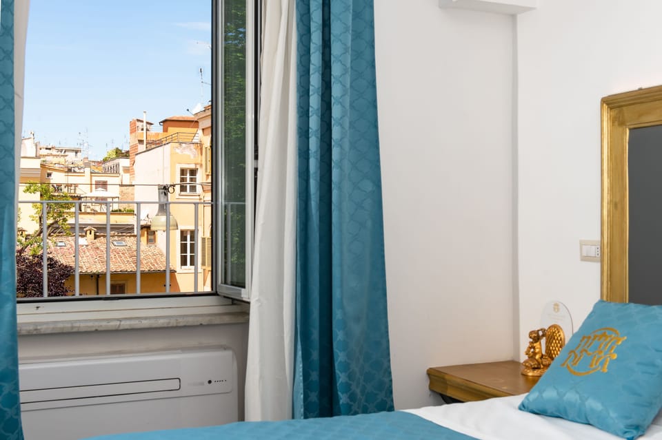 Deluxe Quadruple Room | Minibar, in-room safe, desk, laptop workspace