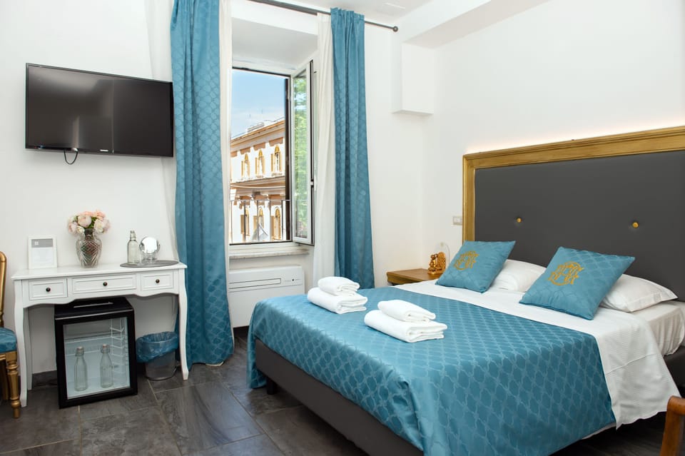 Deluxe Quadruple Room | Minibar, in-room safe, desk, laptop workspace