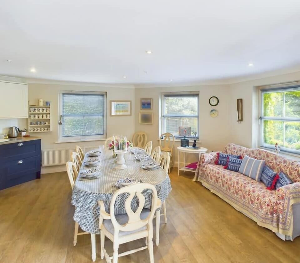 Open-plan kitchen, dining and seating with smart TV. 