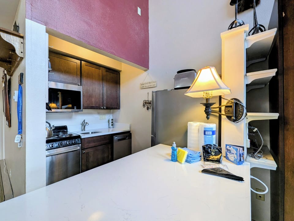 Your fully equipped kitchen features modern appliances and warm lighting, perfect for preparing meals during your stay.