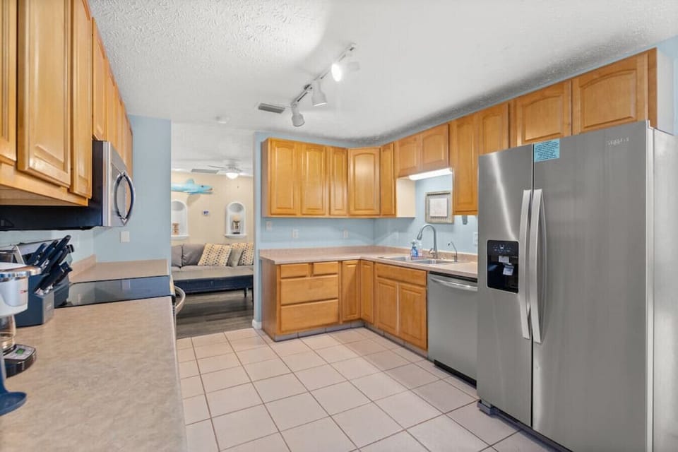 Large kitchen with stainless steel appliances. Fully-stocked and ready for you to whip up a meal for your group!