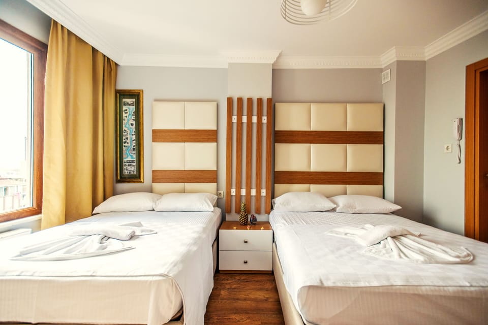 Quadruple Room | Minibar, in-room safe, desk, blackout drapes