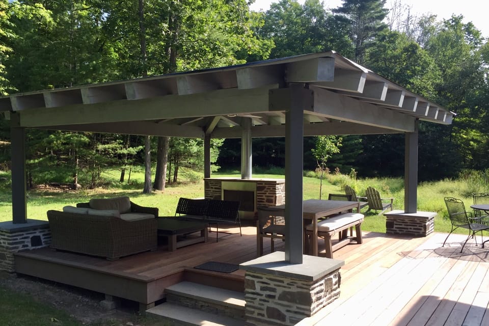 Weather-resistant outdoor room, with fireplace, ceiling fan and lighting
