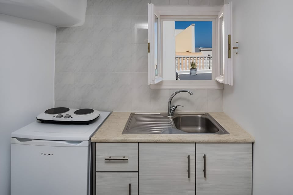 Standard Quadruple Room | Private kitchen | Fridge, electric kettle