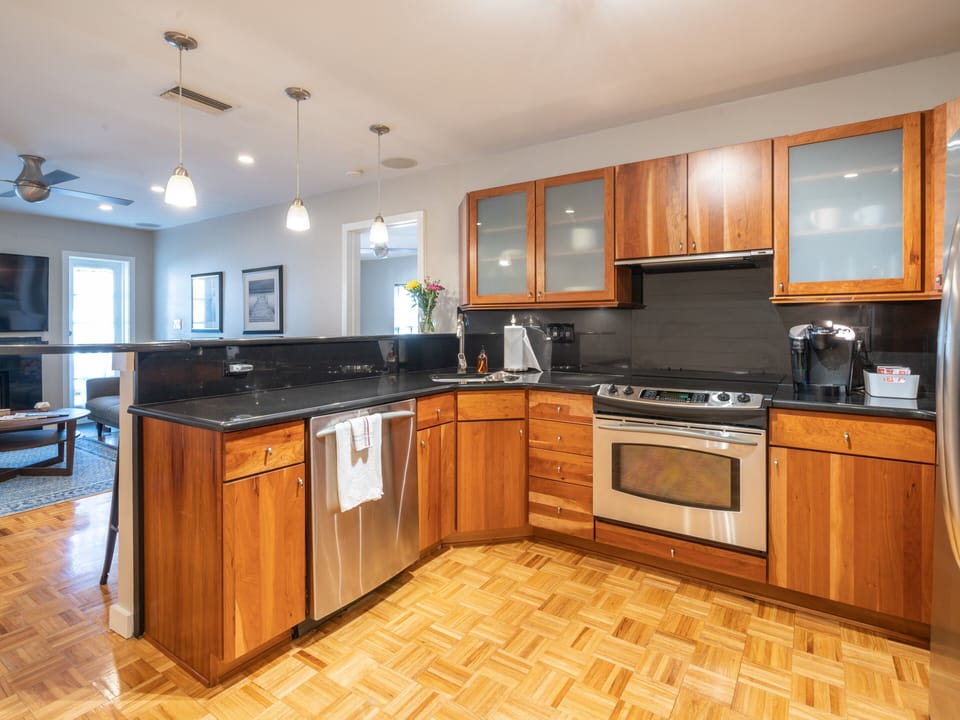 Modern kitchen with all stainless steel appliances. Coffee station. 
