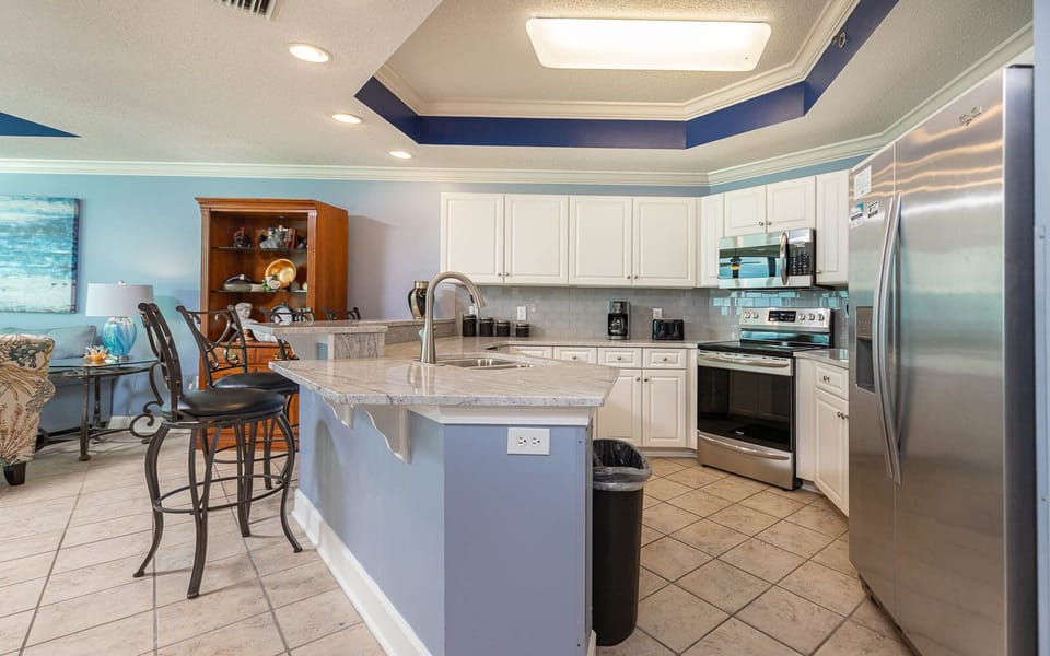 Prepare meals with ease in this spacious kitchen featuring sleek modern appliances and ample counter space for gatherings