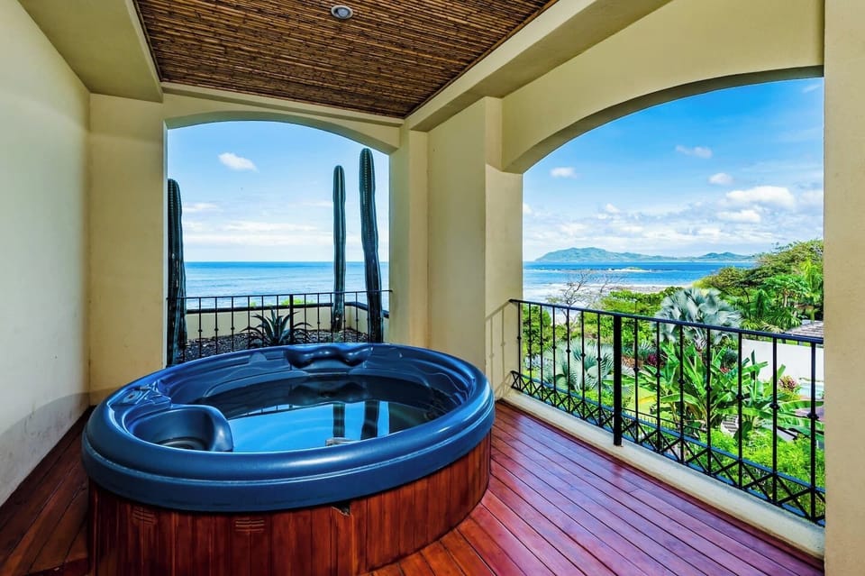 Private Jacuzzi on the beachfront balcony with panoramic ocean views and sunset skies. Unwind in tropical luxury at this Tamarindo vacation rental near Langosta Beach — perfect for couples, honeymooners, or surf travelers.