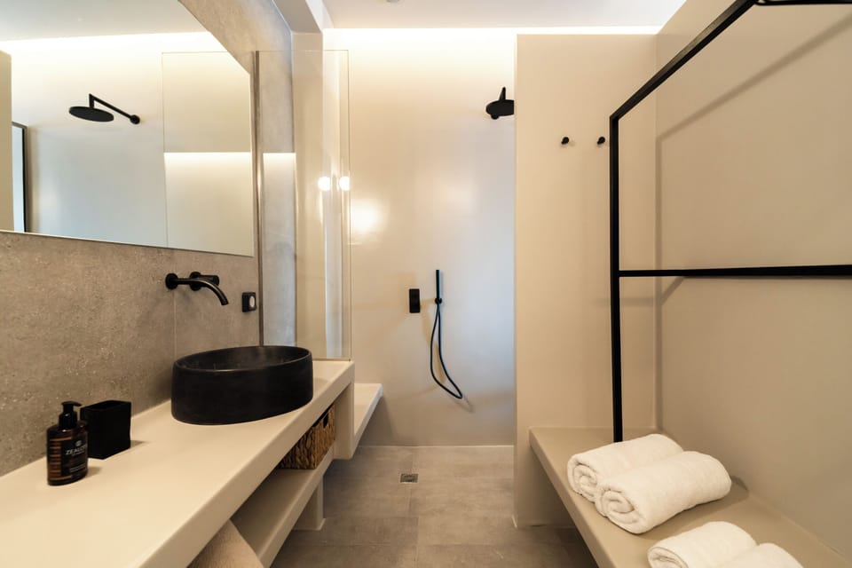 Cosmic Suite with Private Heated Plunge Pool and Caldera View | Bathroom | Shower, rainfall showerhead, hair dryer, slippers