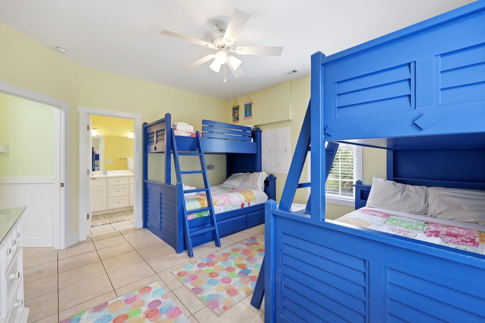 Your kids will love this cheerful bedroom with vibrant blue bunk beds, playful decor, and plenty of space for restful nights and fun mornings together.