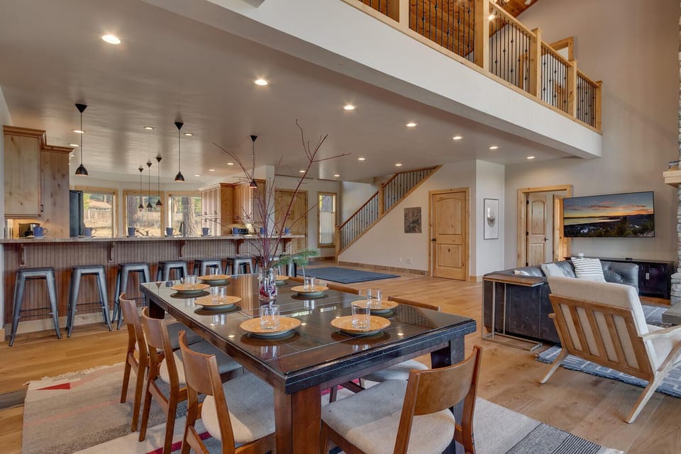 - Elegant dining table with seating for six next to open kitchen  
- Perfect setting for family meals or hosting dinner gatherings  
- Warm wood details and modern lighting enhance cozy charm