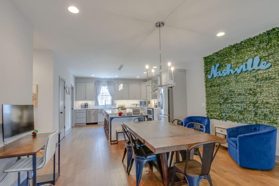 Dining area with farmhouse table, chairs, and pendant lighting
