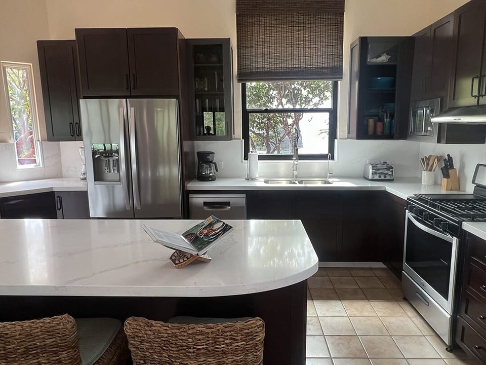 Kitchen window above the stainless steel double sink looks at the Caribbean Sea