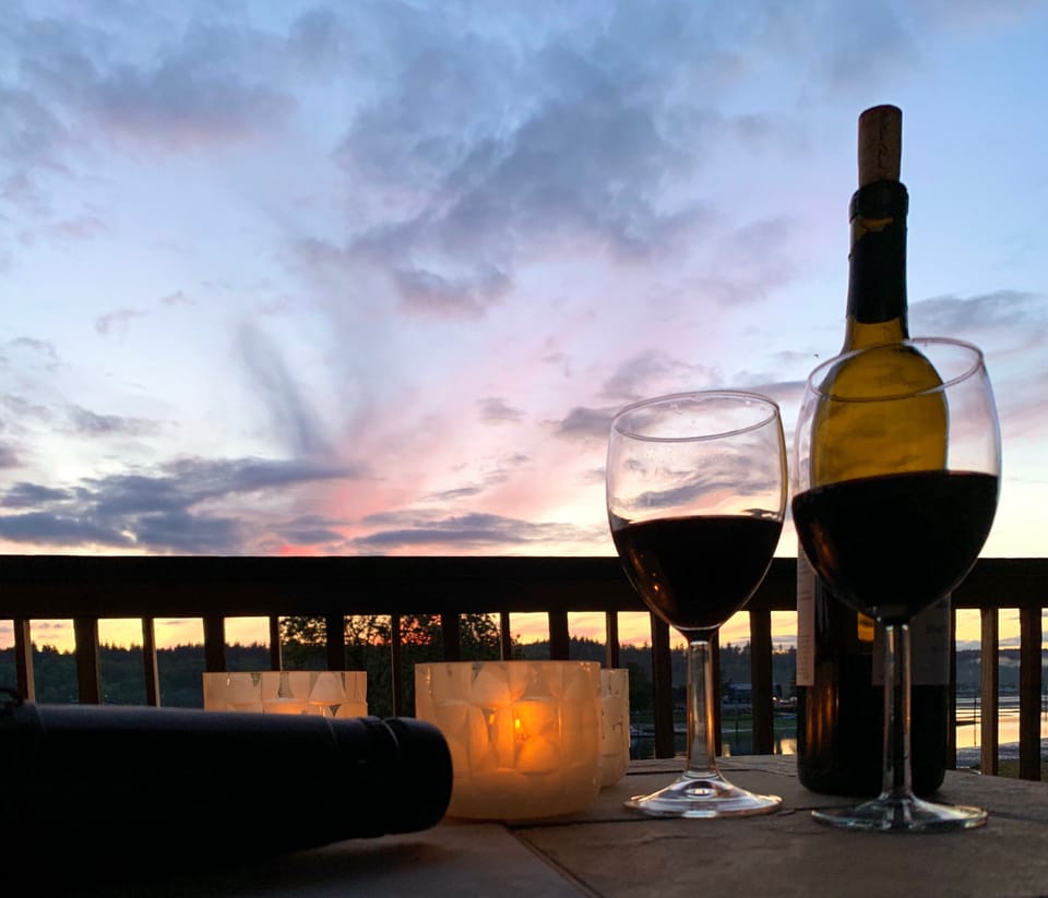 Enjoy glass of wine while watching the sun set behind the Olympic mountain range