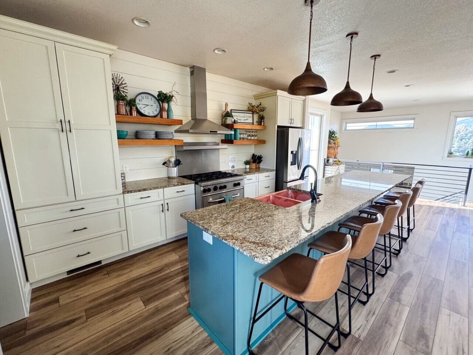 Beautiful kitchen fully stocked with oversized island with plenty of seating for everyone