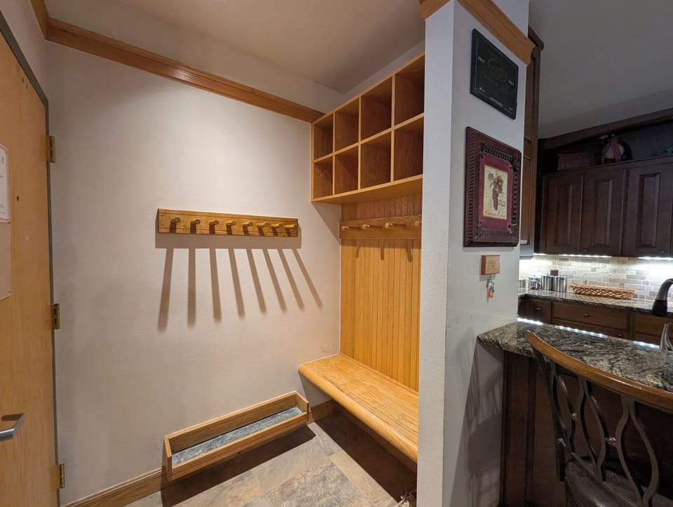 Your private mudroom offers organized storage with cubbies and hooks for ski gear
