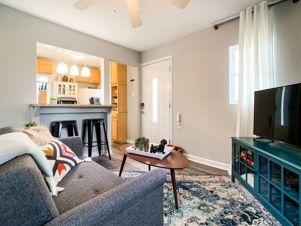 Warm and cozy living area on the main level with small breakfast bar, coffee table, and smart tv at the Hound Haus.