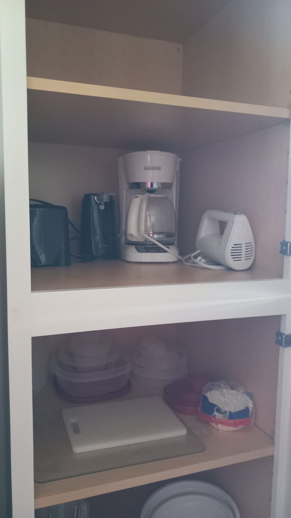 Storage shelf with toaster, drip coffee pot, and mixer,