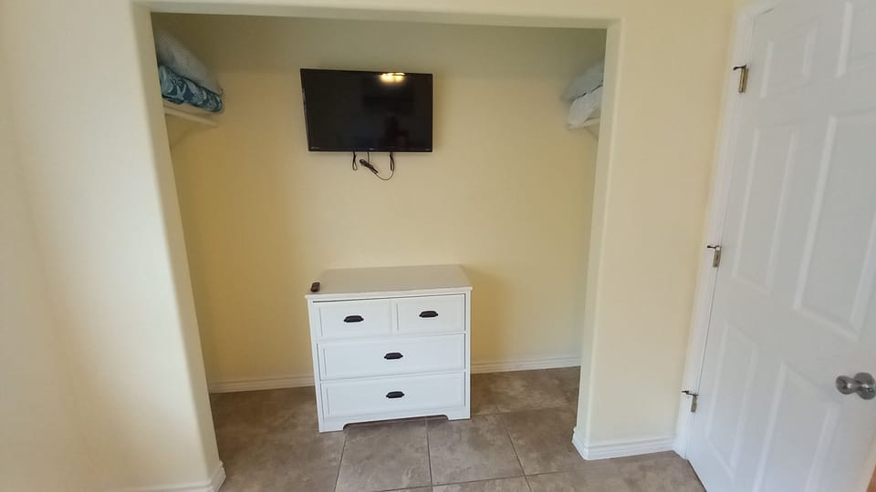 First Bedroom Closet with smart tv and dresser