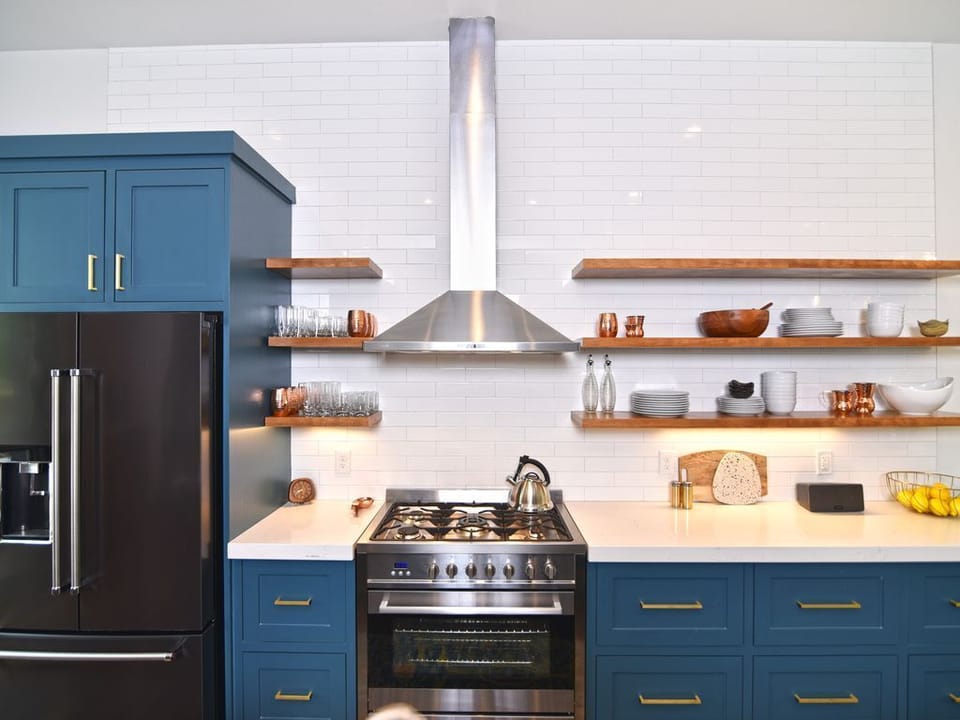 Designer touches abound! Floating shelves, subway tile backsplash, pro gas range