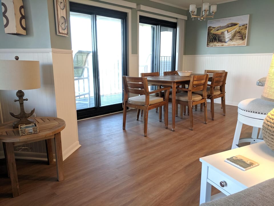 Dining area flows easily from kitchen, oceanfront balcony, and living room.