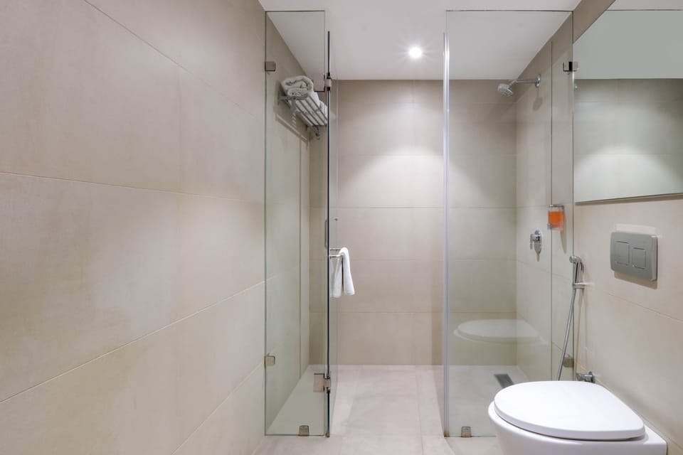 Suite, 1 King Bed, Non Smoking, City View | Bathroom | Shower, rainfall showerhead, towels