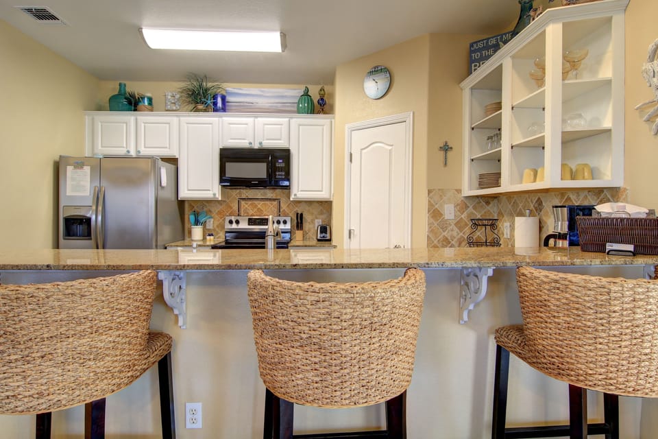 Seating for three at the breakfast bar.