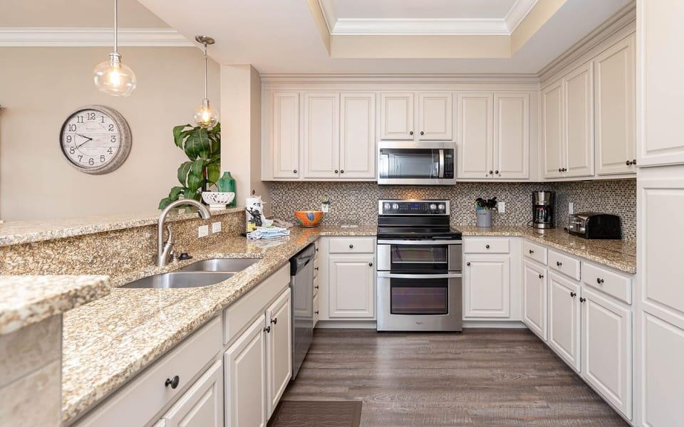 Craft delicious meals surrounded by cheerful colors and stainless appliances in this inviting kitchen space