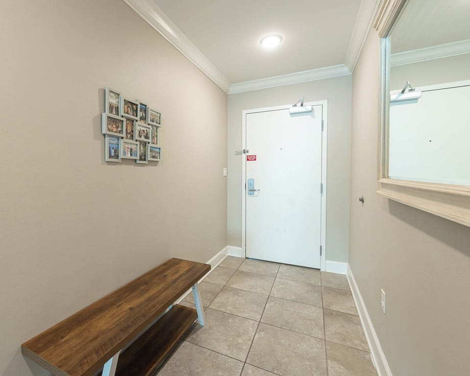 Step into the welcoming entryway, where family memories adorn the walls, inviting you to start your vacation adventure