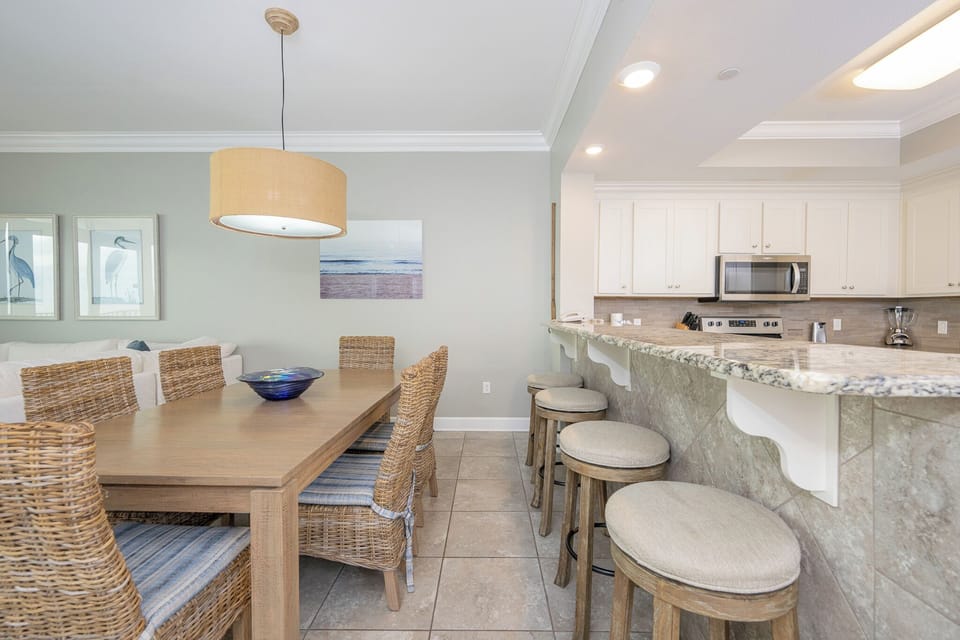 Sip your morning coffee at the breakfast bar and get ready for a beach day in this stylish space