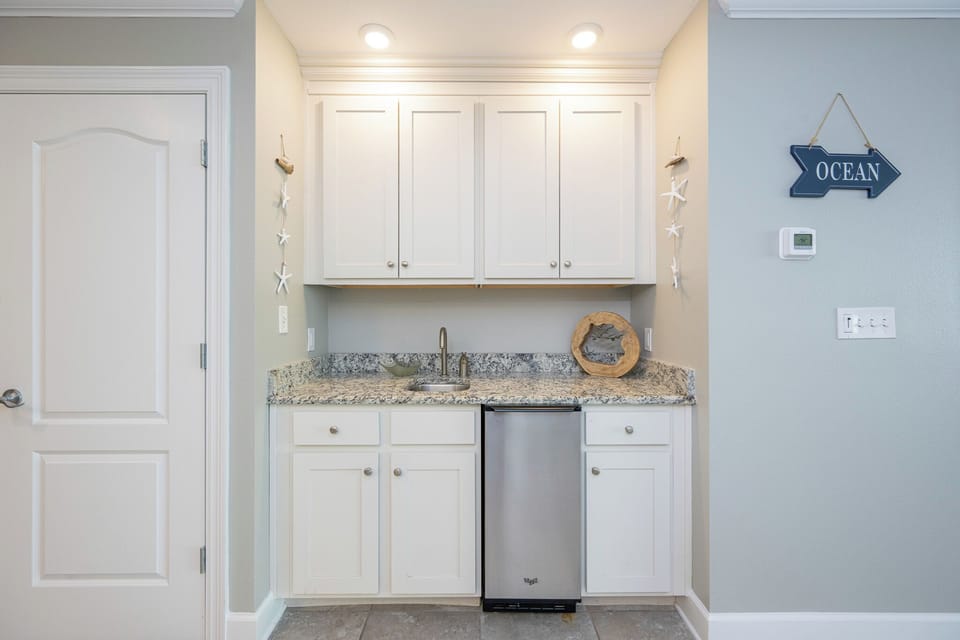 Mix refreshing drinks at the inviting wet bar, where convenience meets comfort, perfect for your beach getaway