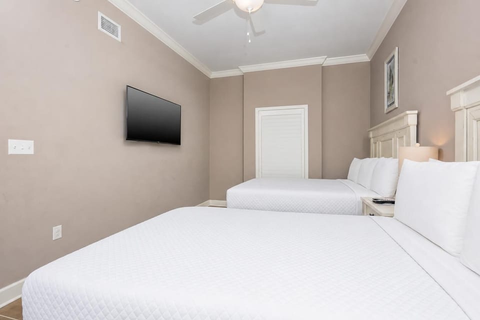 Relax on one of the cozy queen beds in this guest suite and stream your favorite shows after a beach day
