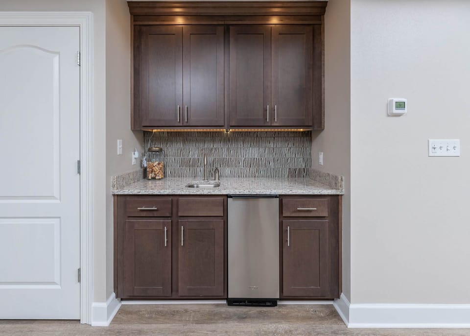 Grab a chilled drink from the fridge or create your favorite cocktail at the wet bar with stylish accents and lighting